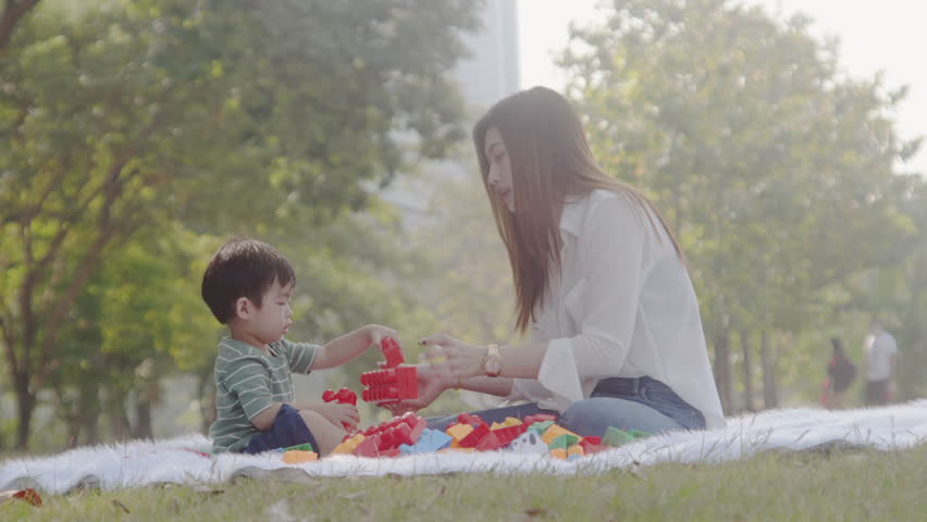 Woman and brother having a picnic in the park
