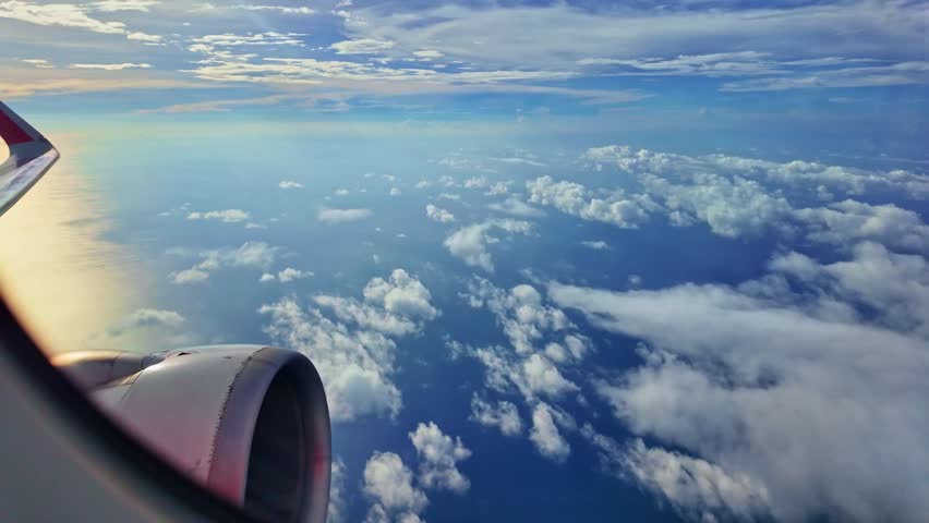 
Looking from the airplane window Propeller and wings next to the window.
an airplane flying past fluffy white clouds.
The slope of the horizon shifts with the plane.
by the airplane window