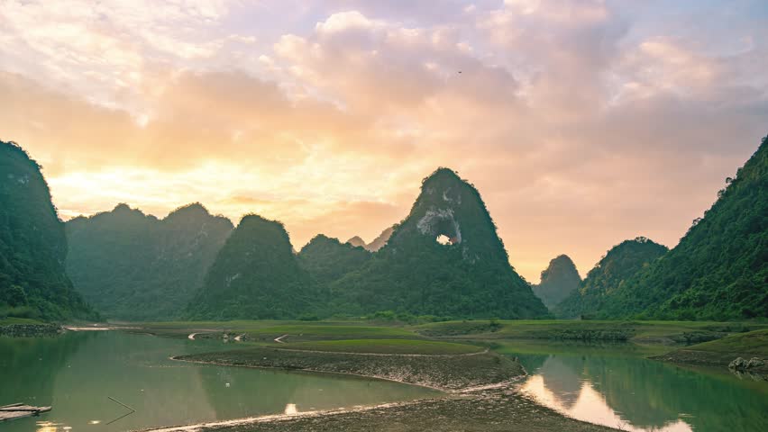 Aerial view of Thung mountain cinematic sunset background in Tra Linh, Cao Bang province, Vietnam with lake, cloudy, nature, camping and fisherman. Travel and landscape concept.Hyper lapse
