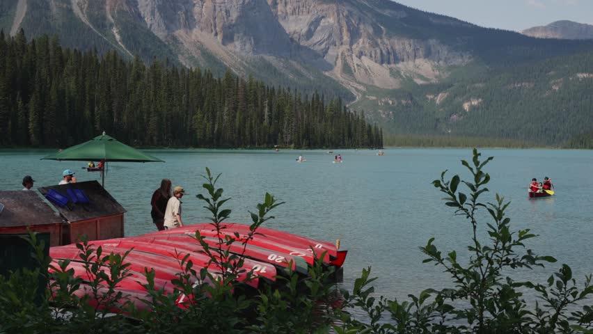 Serene Lake Canoeing Adventure with Mountain Views