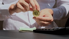 Expert trader hands showing Bitcoin coin digital gold after counting income banknotes of euro cash on calculator. Close up of hands unrecognizable Freelancer. Earned trading charts growth - Powered by Shutterstock - Get 15% off with code: PIKWIZARD15