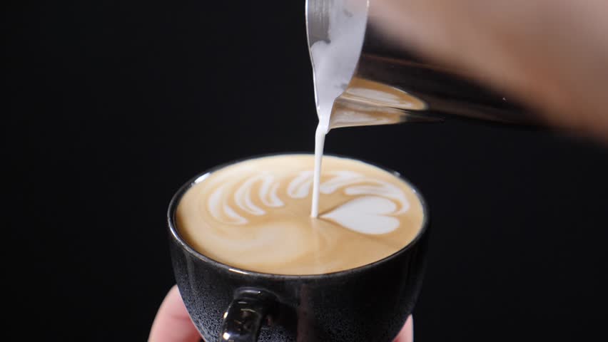 Barista adding foamy milk into cup of coffee. Slow motion. Shot on black background. Bartender preparing cappuccino. Latte art, Milk pouring by Barman. Process of Making Vegan Lactose Free Drink in | Shutterstock HD Video #1111229769
