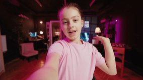 Gen z youngster filming POV style video with phone for online channel, talking with viewers. Kid telling audience topics she wishes to explore in future clips, recording with selfie smartphone camera