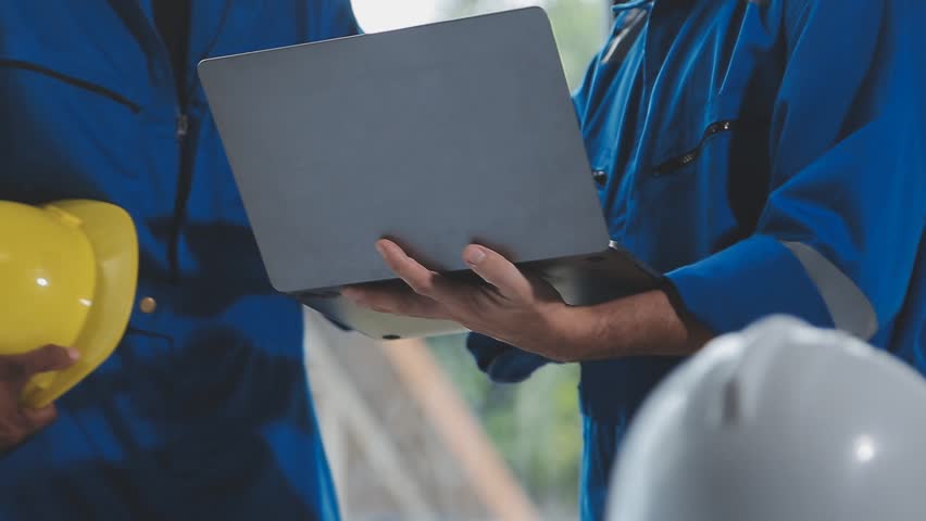 Pipeline Innovation, Engineers Discuss Construction in Digital Factory Setting , A trio of heavy industry engineers stands in a pipe manufacturing factory, utilizing digital tablets for discussion - Powered by Shutterstock - Get 15% off with code: PIKWIZARD15