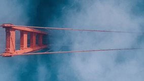 Aerial of red Golden Gate bridge. Busy road of red bridge over deep blue Pacific Ocean waters. Top down fog drifting around industrial architecture construction in San Francisco bay, California USA 4K