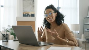 Assertive smart serious woman of color arguing about project looking at webcam. Business Entrepreneur shaking head in disagreement communicating with colleagues or partners on video call app laptop