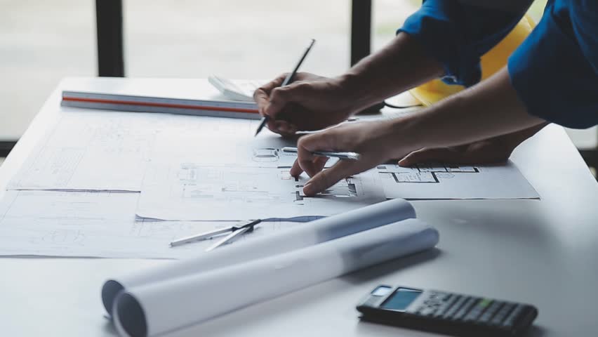 Pipeline Innovation, Engineers Discuss Construction in Digital Factory Setting , A trio of heavy industry engineers stands in a pipe manufacturing factory, using digital tablets for discussion - Powered by Shutterstock - Get 15% off with code: PIKWIZARD15