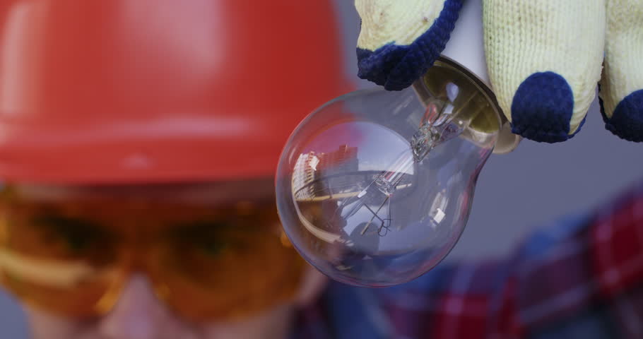 An electrician screws a light bulb into the socket, the light bulb does not work or there is no electric current. The light from the bulb does not appear immediately.