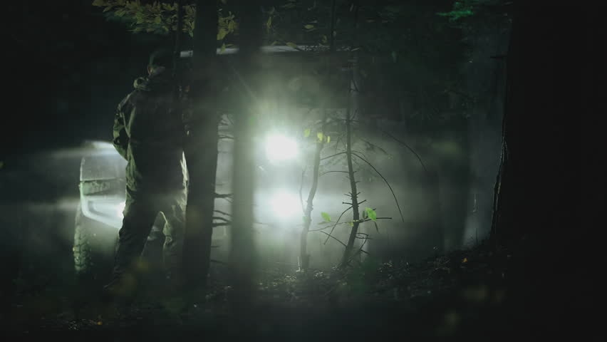 Caucasian Off Roading Man with a Winch Rope in His Hand Preparing For Recovery at Night Close Up Photo