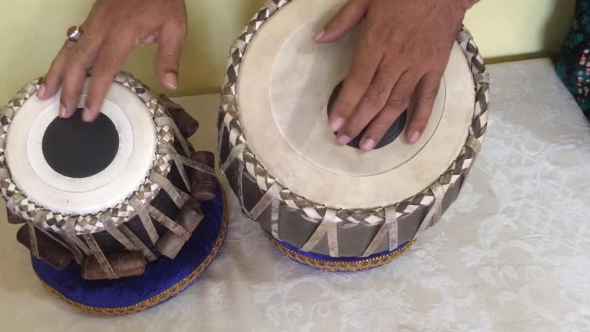 Close-up of hands of an Indian man playing a paired tabla drum. A pair of hand on a drum. A pair of hand playing drums. Royalty-Free Stock Footage #1111243607