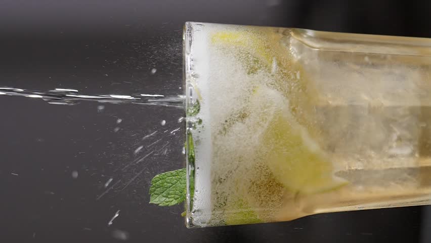Barman pouring soda water while making cocktail at night club or pub. Slow motion. Vertical footage. soda bubbles. close-up. Bartender gently pours bottled carbonated drink with soda bubbles into | Shutterstock HD Video #1111244109