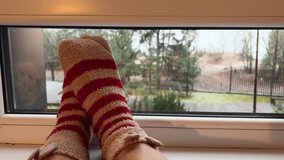 POV chilling at window in winter. Cozy time indoors watching nature. Putting feet on window sill. Autumn snow background. Fall time. Film grain pixel texture. Soft focus. Live camera. Blur. - Powered by Shutterstock - Get 15% off with code: PIKWIZARD15