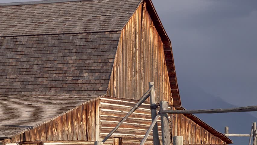John Moulton barn, Mormon Row Histroric District, Grand Teton National Park mountain range, Wyoming, USA, zoom out reveal
