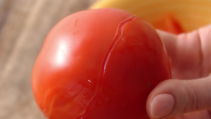 Close-up shot of Peeling Tomato Skin.