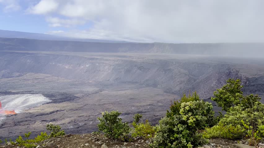 Cinematic wide panning shot of lava and volcanic gasses pouring from Kilauea mere moments after eruption began in September 2023 at Hawai