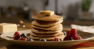 Traditional American breakfast with hot pancakes served with berries. No people, advertising cinematic. Healthy eating with gluten-free, sugar-free recipes and gluten-free food options. Art of cooking