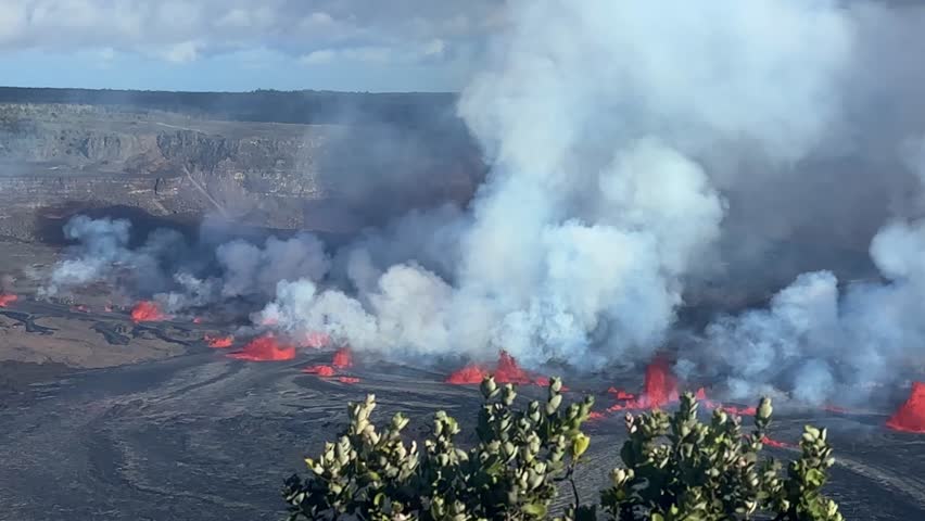 Cinematic long lens shot of lava fountains erupting from Kilauea Volcano on the first day of activity in September 2023 at Hawai
