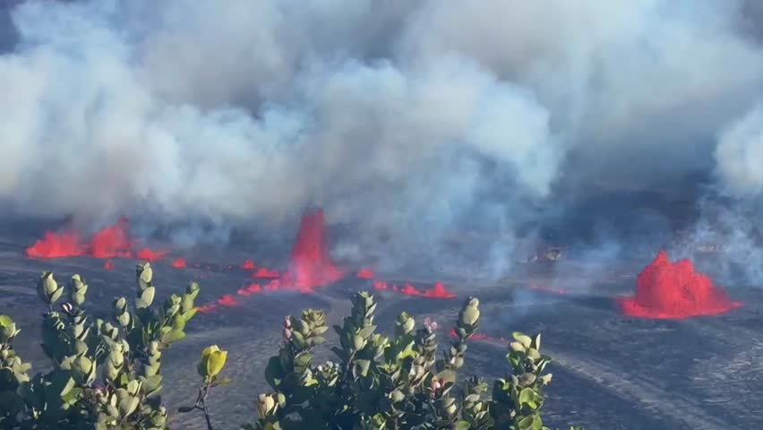Cinematic long lens panning shot of lava fountains spewing from Kilauea in the afternoon of the first day of eruption in September 2023 at Hawai