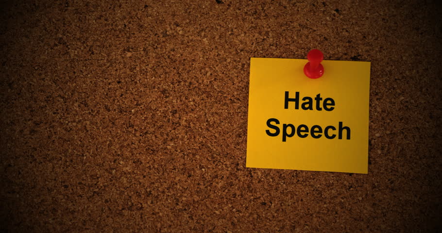 A yellow paper note with the words Hate Speech on it pinned to a cork board. Close up. | Shutterstock HD Video #1111261801
