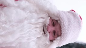 Santa Claus with a real beard and a big smile with a thumbs up. Vertical video.
