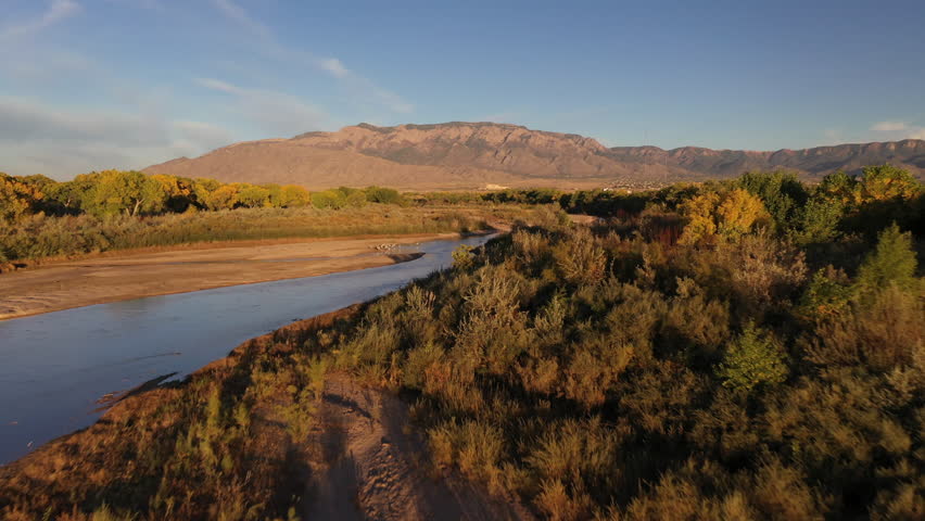 Rio Grande Bosque in the Fall - Aerial over Rio Grande River with Sandia Mountains in the background, edge of Albuquerque showing next to Sandia Pueblo Lands