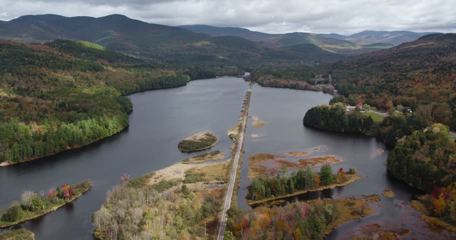 Railroad Tracks over Lake in Breathtaking New England Fall Scenery, Aerial