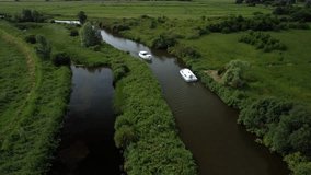 Aerial Drone 4k Footage of Boats passing each other in a section of the River Yare, Norfolk Broads, Norfolk.