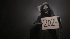 Grim reaper holding a 2024 sign in his hands and dancing, on a black background. Symbolism and superstition. New Year. Halloween characters concept. - Powered by Shutterstock - Get 15% off with code: PIKWIZARD15