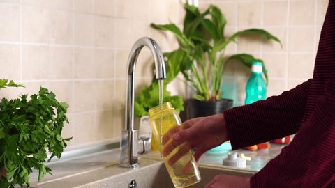Reusable water bottle. Plastic free. Zero Waste Lifestyle. Man pours water from the tap - Βίντεο στοκ