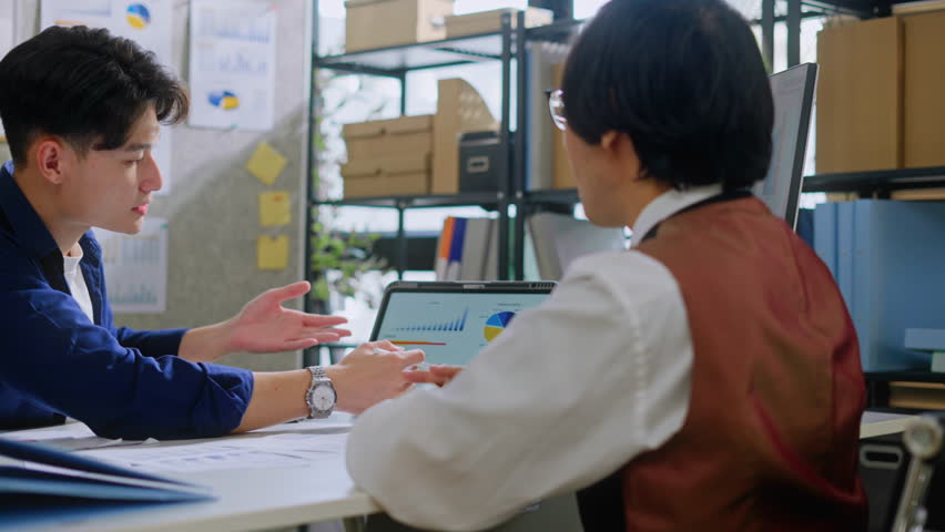 young asian businessman presentation with digital tablet to a Manager in company office.Teamwork,collaboration and brainstorming,strategy and goal,mentor coach,worker learn new skills in office.