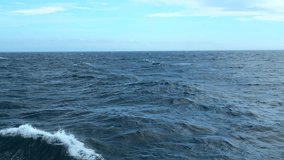 Waves from floating sea vessel. Clip. Beautiful moving waves from floating ship at sea. Beautiful sea horizon with moving waves from ship