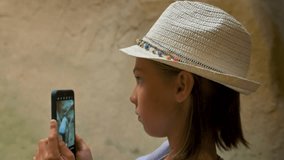 Tourist girl making photo in cavern. 4k video footage UHD 3840x2160
