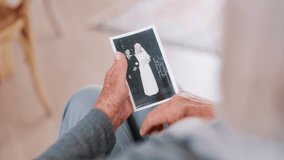 Photograph, memory and old woman in home remember wedding, event and marriage with nostalgia. Elderly, hands and mourning death of husband or man in vintage picture with love and thinking of history - Powered by Shutterstock - Get 15% off with code: PIKWIZARD15