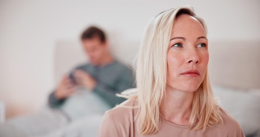 Woman, thinking and conflict of couple in bedroom with stress, breakup or toxic relationship at home. Face of frustrated partner in crisis, divorce and fight for cheating, affair or trauma of mistake | Shutterstock HD Video #1111278803