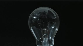 Animation of lit light bulb over mathematical data processing. Global science, computing and data processing concept digitally generated video.