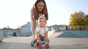 mother teaches son baby to ride skateboard. happy family kid dream concept. child baby rides a skateboard dad helps. mother day concept. child playing riding a skateboard lifestyle outdoors - Powered by Shutterstock - Get 15% off with code: PIKWIZARD15
