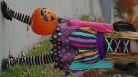 Portrait of girl wearing halloween witch costume in neighborhood - vertical video, cedar hills, utah, united states - Powered by Shutterstock - Get 15% off with code: PIKWIZARD15
