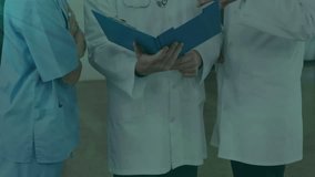 Animation of flowchart of icons over caucasian doctors discussing patient reports in hospital. Digital composite, multiple exposure, communication, ideas, protection, teamwork and medical concept. - Powered by Shutterstock - Get 15% off with code: PIKWIZARD15