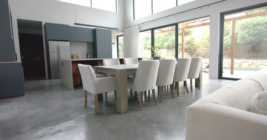 Interior of bright open plan dining room and kitchen with doors to garden, copy space, slow motion. Home, property, house, interior decor, architecture and domestic life.