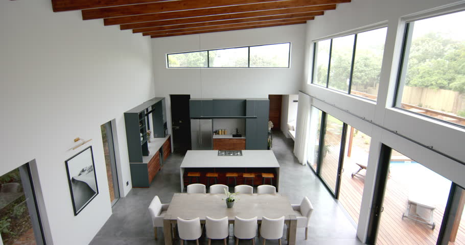 High angle view of open plan living room, dining room and kitchen, copy space, slow motion. Home, property, house, interior decor, architecture and domestic life.