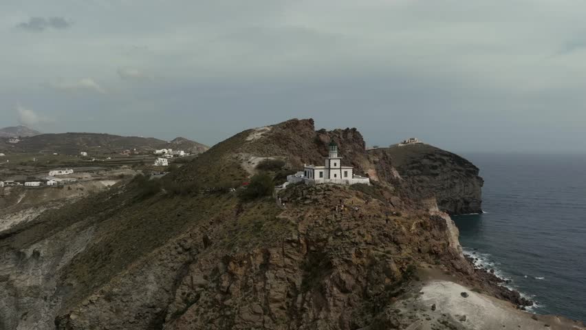 Drone view of lighthouse in Santorini in Greece, an island in the Cyclades. View of the magnificent white houses of Fira and Oia | Shutterstock HD Video #1111307393