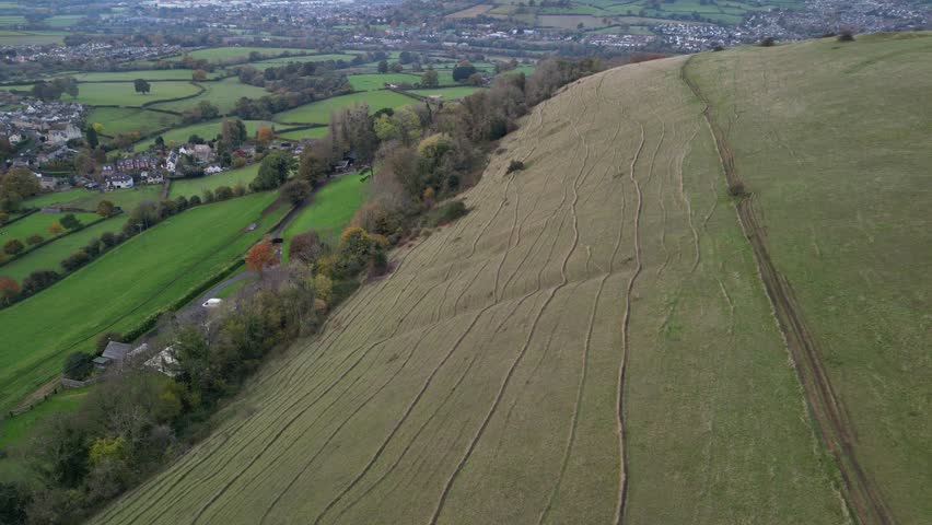 Aerial view of a hilltop with walking trails at sunset