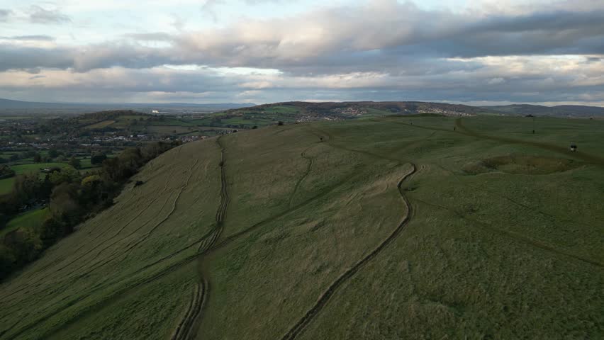Aerial view of hilltop with walking trails at sunset