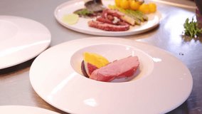 Close up video of chef making plating in white plate in restaurant
