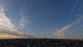 Clear sky, blue clouds. Video for meditation and relaxation. Time-lapse photography of the sunset sky in 4K UHDTV resolution. Cityscape. Slow motion