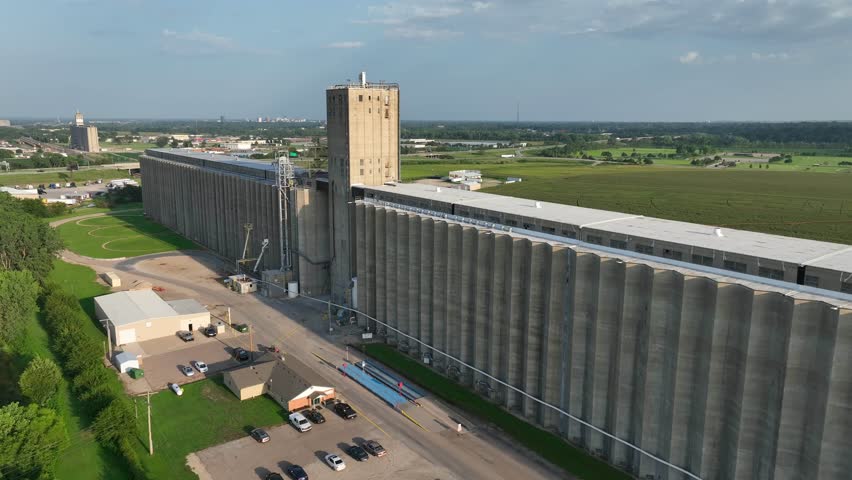 Massive concrete grain elevator towers over the flat landscape in Topeka, Kansas. Aerial shot of Cargill storage.
