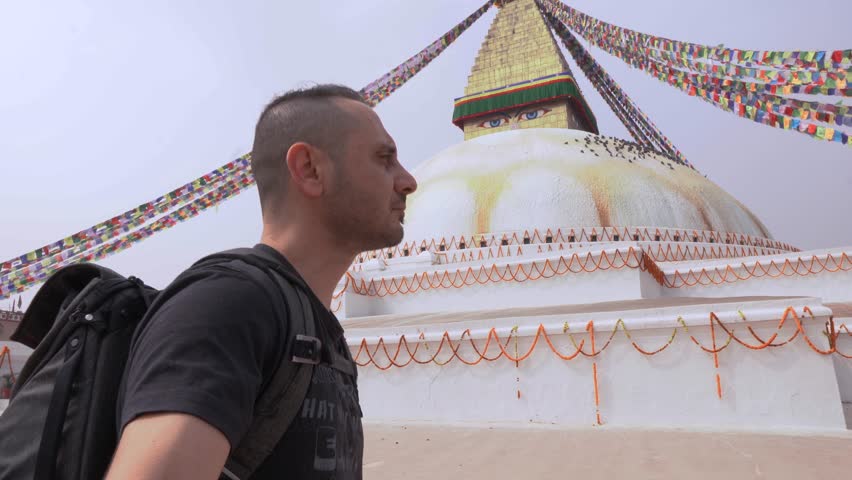 Tourist man visit Boudhanath Buddhist Temple or Buddha Stupa in Kathmandu, Nepal