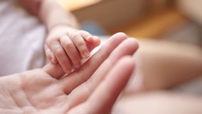 mother holding baby newborn hand. friendly family kid dream concept. mothers day concept. baby newborn in mother lifestyle arms close-up hand - Powered by Shutterstock - Get 15% off with code: PIKWIZARD15