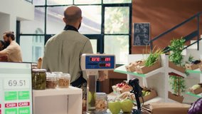 Seller shows freshly harvested apples to diverse couple in local zero waste eco shop, customers supporting organic farming for sustainable lifestyle. Storekeeper presenting ripe fresh fruits. - Powered by Shutterstock - Get 15% off with code: PIKWIZARD15