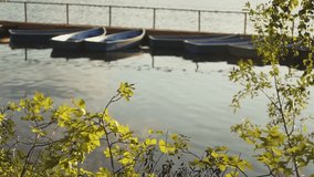 pond and catamaran. autumn foliage and two wooden boats. slow motion video. High quality shooting in 4K format